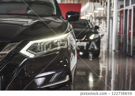 The headlights and the hood of a black luxury car 122736659