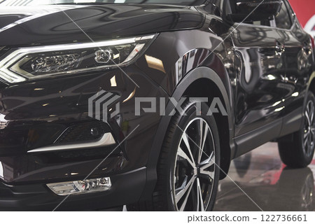 The headlights and the hood of a black luxury car The headlights and the hood of a black luxury car 122736661