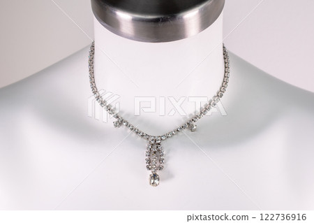Unique necklace on a white mannequin, promotional photo for an online vintage and handmade jewelry store Unique necklace on a white mannequin, promotional photo for an online vintage and handmade jewelry store 122736916