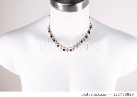 Unique necklace on a white mannequin, promotional photo for an online vintage and handmade jewelry store 122736929