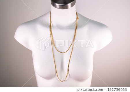 Unique necklace on a white mannequin, promotional photo for an online vintage and handmade jewelry store 122736933