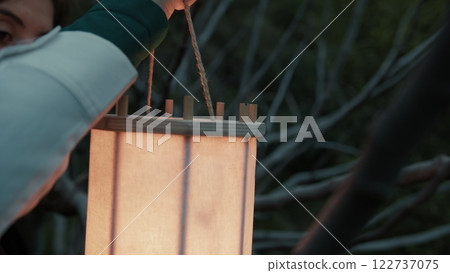 Mysterious Lantern Held By A Woman Among Ancient Trees At Night In Darkness Mysterious Lantern Held By A Woman Among Ancient Trees At Night In Darkness 122737075