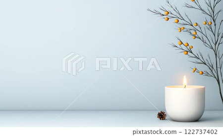 serene white candle holder with flickering candle, surrounded by delicate branches and berries, creates calming atmosphere 122737402