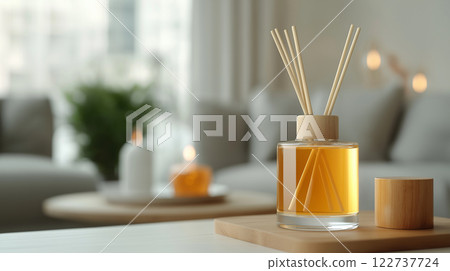 Aromatic diffuser with reeds in cozy living room setting, creating warm ambiance 122737724
