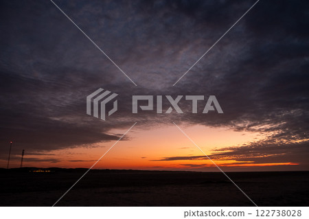 A Stunning and Colorful Sunset Over a Peaceful, Tranquil Landscape with Dramatic Clouds Above A Stunning and Colorful Sunset Over a Peaceful, Tranquil Landscape with Dramatic Clouds Above 122738028