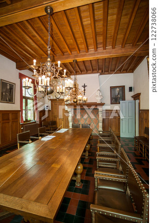 An Elegant Conference Room Featuring Beautiful Wooden Decor and an Exquisite Chandelier An Elegant Conference Room Featuring Beautiful Wooden Decor and an Exquisite Chandelier 122738066