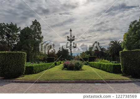 Ornamental Lamppost Amidst Hedges Garden Serenity: Ornamental Lamppost Amidst Hedges and Trees Under Sunny Skies Ornamental Lamppost Amidst Hedges Garden Serenity: Ornamental Lamppost Amidst Hedges and Trees Under Sunny Skies 122738569
