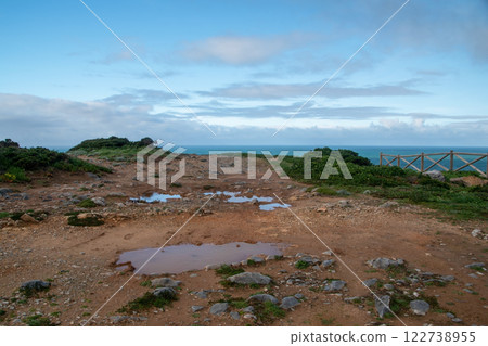 Panorama of the ocean coast and rock bay, Atlantic Ocean in winter, stormy sea waves with white lambs roll ashore with sheer rocks, beautiful cloudscape, dramatic landscape, gloomy seascape 122738955