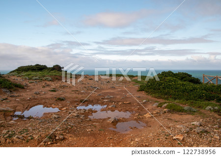 Panorama of the ocean coast and rock bay, Atlantic Ocean in winter, stormy sea waves with white lambs roll ashore with sheer rocks, beautiful cloudscape, dramatic landscape, gloomy seascape Panorama of the ocean coast and rock bay, Atlantic Ocean in winter, stormy sea waves with white lambs roll ashore with sheer rocks, beautiful cloudscape, dramatic landscape, gloomy seascape 122738956