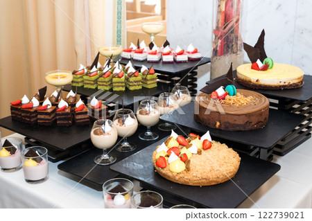 Party reception. Dessert buffet. A table filled with assortment of deserts. Catering for an event. Party reception. Dessert buffet. A table filled with assortment of deserts. Catering for an event. 122739021