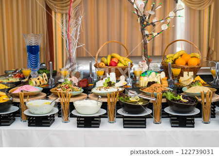 Snacks for the holiday, catering. Various snacks. Assortment of salads and buffet dishes. Meat, fish, cheese, salads, fruits and vegetables, sauces and canapes for celebrating a festive event. Snacks for the holiday, catering. Various snacks. Assortment of salads and buffet dishes. Meat, fish, cheese, salads, fruits and vegetables, sauces and canapes for celebrating a festive event. 122739031