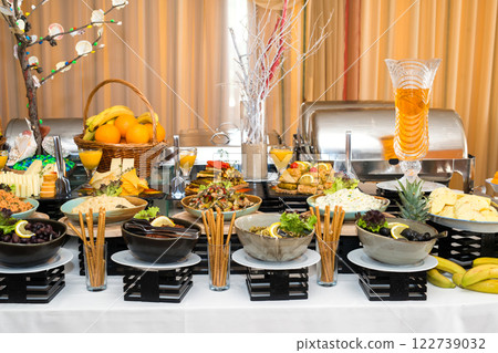 Snacks for the holiday, catering. Various snacks. Assortment of salads and buffet dishes. Meat, fish, cheese, salads, fruits and vegetables, sauces and canapes for celebrating a festive event. 122739032