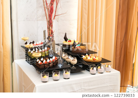Party reception. Dessert buffet. A table filled with assortment of deserts. Catering for an event. Party reception. Dessert buffet. A table filled with assortment of deserts. Catering for an event. 122739033