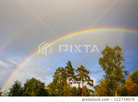 Double rainbow in the summer sky above the forest. Double rainbow in the summer sky above the forest. 122739070