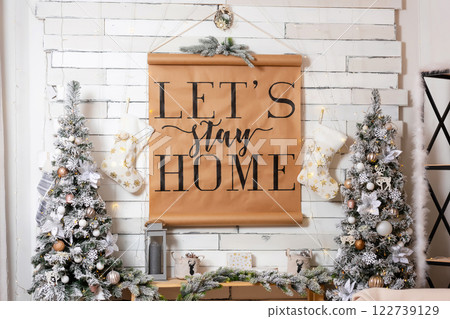Christmas decoration with snowy trees paper poster. New Year interior with New Year decor on shelves Christmas decoration with snowy trees paper poster. New Year interior with New Year decor on shelves 122739129