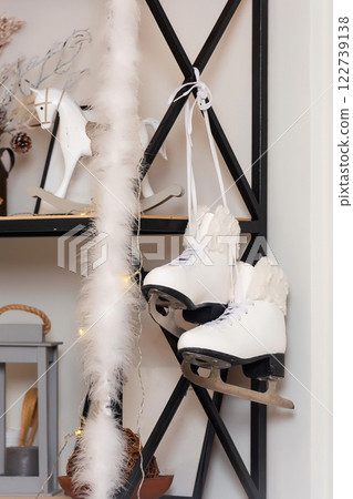 white winter skates on the shelf. ice skates on the decoration in the photo studio 122739138