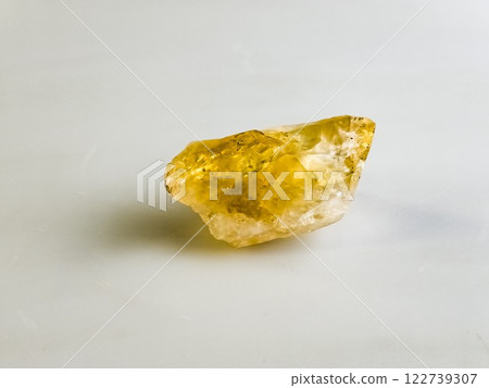 Natural stone of untreated citrine crystal, yellow quartz. Selective focus, white background 122739307