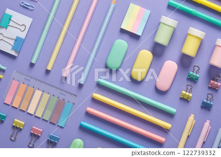 Stationery background with pastel-colored stationery neatly arranged on a light purple background. 122739332