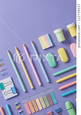 Stationery banner in green, yellow, pink and blue pastel colors on light purple background. Space for your text. 122739337