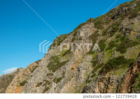 Green hills, meadows and blue sky with white clouds, natural landscape, wild nature 122739428