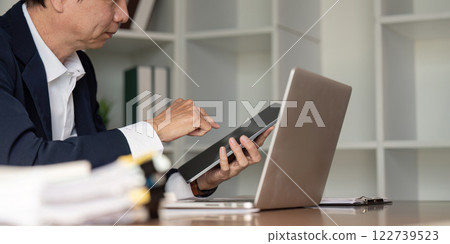 Elderly businessman analyzing data in modern office business environment strategic insight 122739523