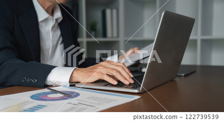 Elderly businessman analyzing reports in modern office setting professional environment focus on productivity 122739539