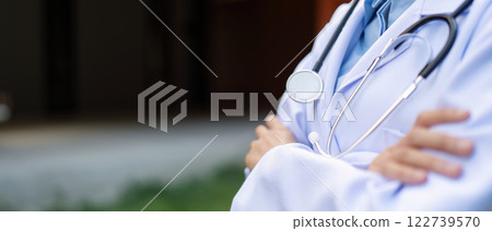Dedicated doctor in a white coat with stethoscope, embodying healthcare professionalism. Dedicated doctor in a white coat with stethoscope, embodying healthcare professionalism. 122739570