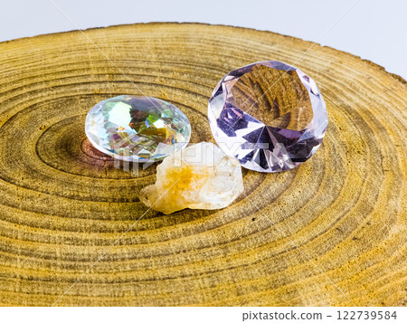 Various types of crystal quartz, citrine and rose quartz on a wood background Various types of crystal quartz, citrine and rose quartz on a wood background 122739584