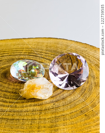 Various types of crystal quartz, citrine and rose quartz on a wood background. Vertical Various types of crystal quartz, citrine and rose quartz on a wood background. Vertical 122739585