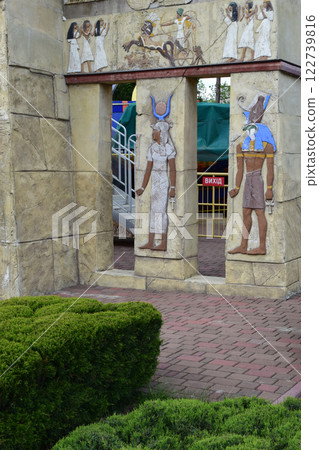 Kharkov, Ukraine, 14 May 2024. A decorative structure styled like an ancient Egyptian entrance, featuring relief carvings of Egyptian figures on both sides of the pillars. Kharkov, Ukraine, 14 May 2024. A decorative structure styled like an ancient Egyptian entrance, featuring relief carvings of Egyptian figures on both sides of the pillars. 122739816