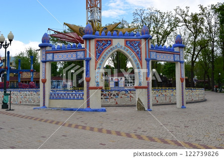 Kharkov, Ukraine, 14 May 2024. A brightly colored, ornate archway in a public area, likely in a park or amusement setting. Vibrant Ornate Archway Kharkov, Ukraine, 14 May 2024. A brightly colored, ornate archway in a public area, likely in a park or amusement setting. Vibrant Ornate Archway 122739826