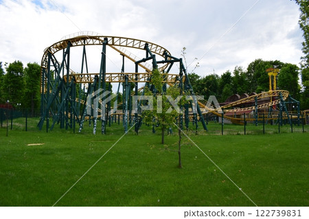 Kharkov, Ukraine, 14 May 2024. A roller coaster of metal structure with yellow rails and dark green support. Thrilling Coaster Adventure 122739831