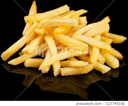 Golden Crispy French Fries on reflective Black Background 122740192