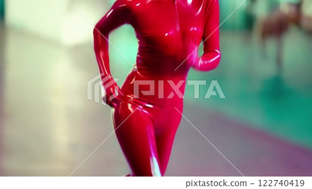 Performer running in a red latex suit 122740419
