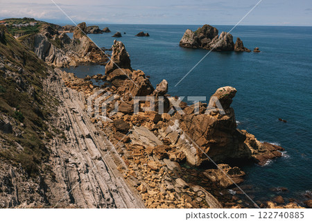A dramatic coastal landscape with layered rock formations and rugged cliffs A dramatic coastal landscape with layered rock formations and rugged cliffs 122740885