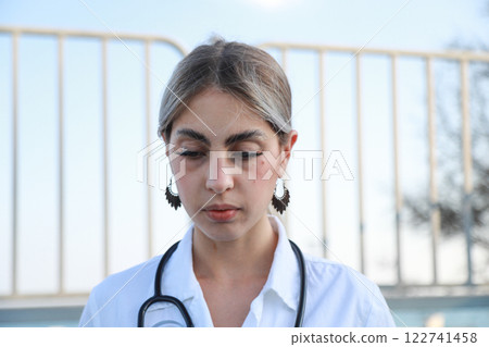 Woman Doctor Administering Treatment in an Outdoor Camp Woman Doctor Administering Treatment in an Outdoor Camp 122741458