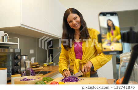 Young woman is broadcasting live from workshop how to prepare a vegetarian food 122741870
