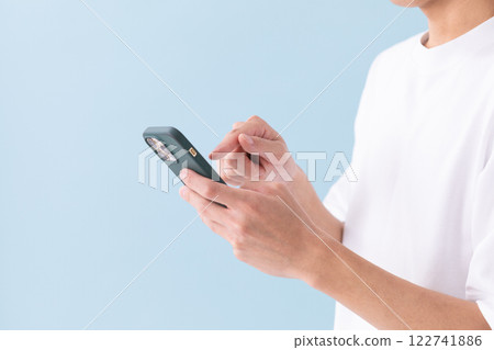 Image of a man operating a smartphone (stock photo) Image of a man operating a smartphone (stock photo) 122741886