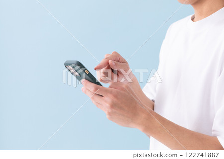 Image of a man operating a smartphone (stock photo) Image of a man operating a smartphone (stock photo) 122741887