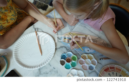 A young mother and her daughter enjoy a creative art session at home A young mother and her daughter enjoy a creative art session at home 122741918