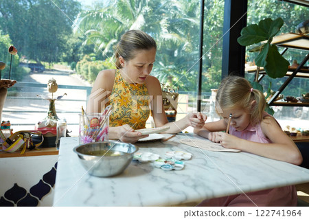 A young mother and her daughter enjoy a creative art session at home A young mother and her daughter enjoy a creative art session at home 122741964