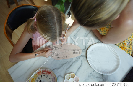 A young mother and her daughter enjoy a creative art session at home A young mother and her daughter enjoy a creative art session at home 122741993