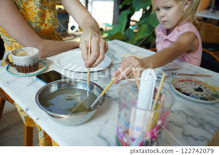 A young mother and her daughter enjoy a creative art session at home A young mother and her daughter enjoy a creative art session at home 122742079