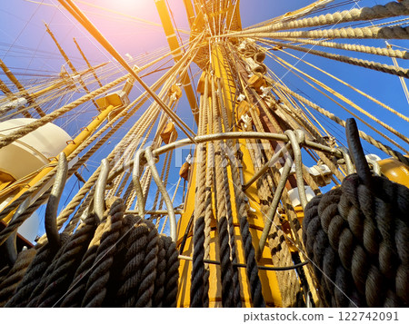 Ropes stretched across the masts of an old ship Ropes stretched across the masts of an old ship 122742091