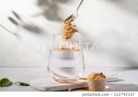 Protein collagen pink powder, fruits and vegetables powder, food supplement in a glass with water Protein collagen pink powder, fruits and vegetables powder, food supplement in a glass with water 122742187