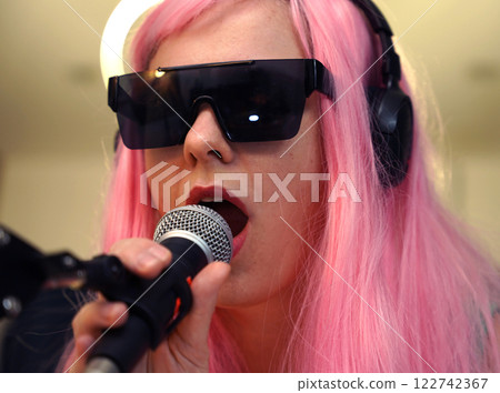 Beautiful young singer and musician broadcast from her home studio 122742367