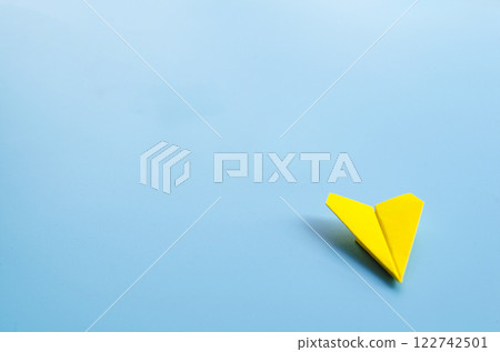 Low view of origami yellow paper airplane with customizable space for text. Low view of origami yellow paper airplane with customizable space for text. 122742501