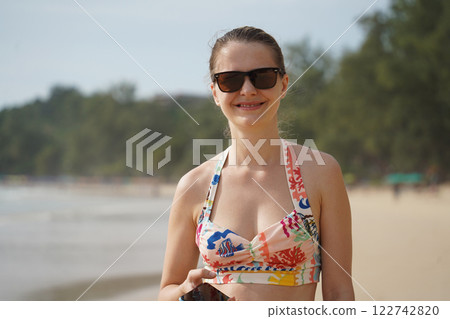 A young woman enjoying a beautiful day at the beach  122742820