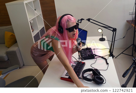 Beautiful young singer and musician broadcast from her home studio 122742921