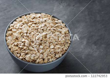 Uncooked Rolled Oats in Bowl for Vegan Breakfast and Weight Loss Nutrition, Copy Space Uncooked Rolled Oats in Bowl for Vegan Breakfast and Weight Loss Nutrition, Copy Space 122742953